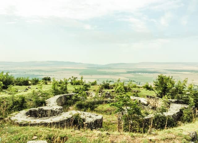 Kilsədağda dairəvi alban məbədinin daş özül qalıqları və geniş düzənlik mənzərəsi.